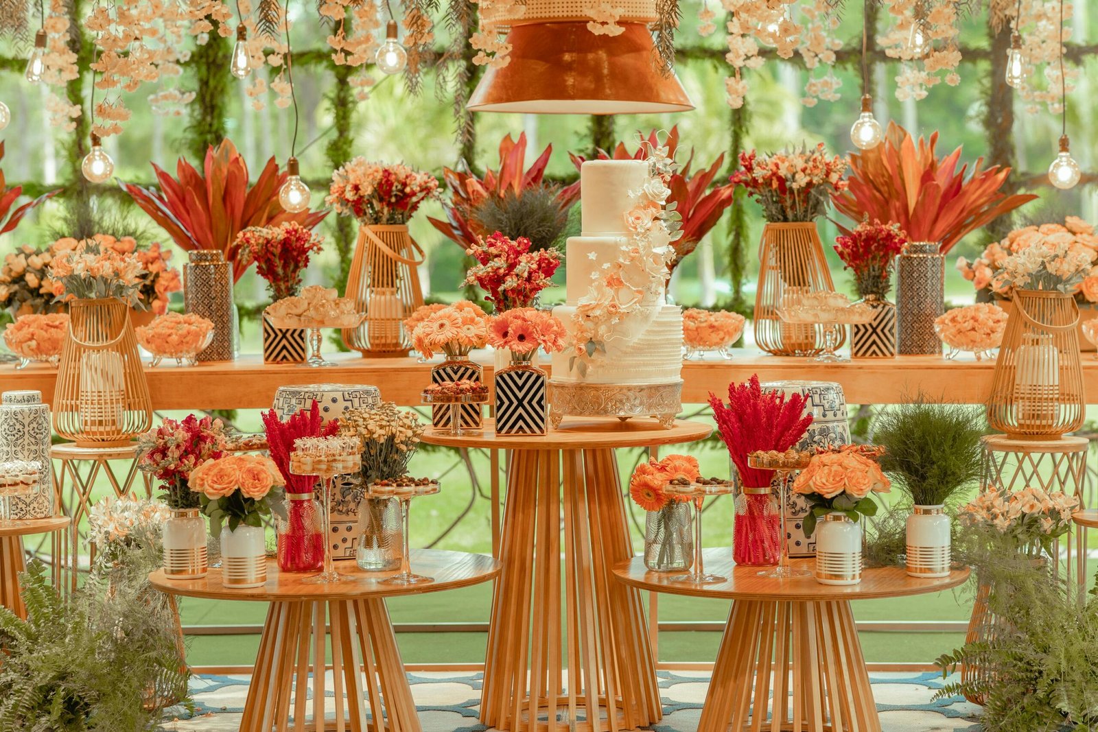 A festive table displaying a cake, fresh flowers, and lit candles, beautifully designed for birthday and wedding events.