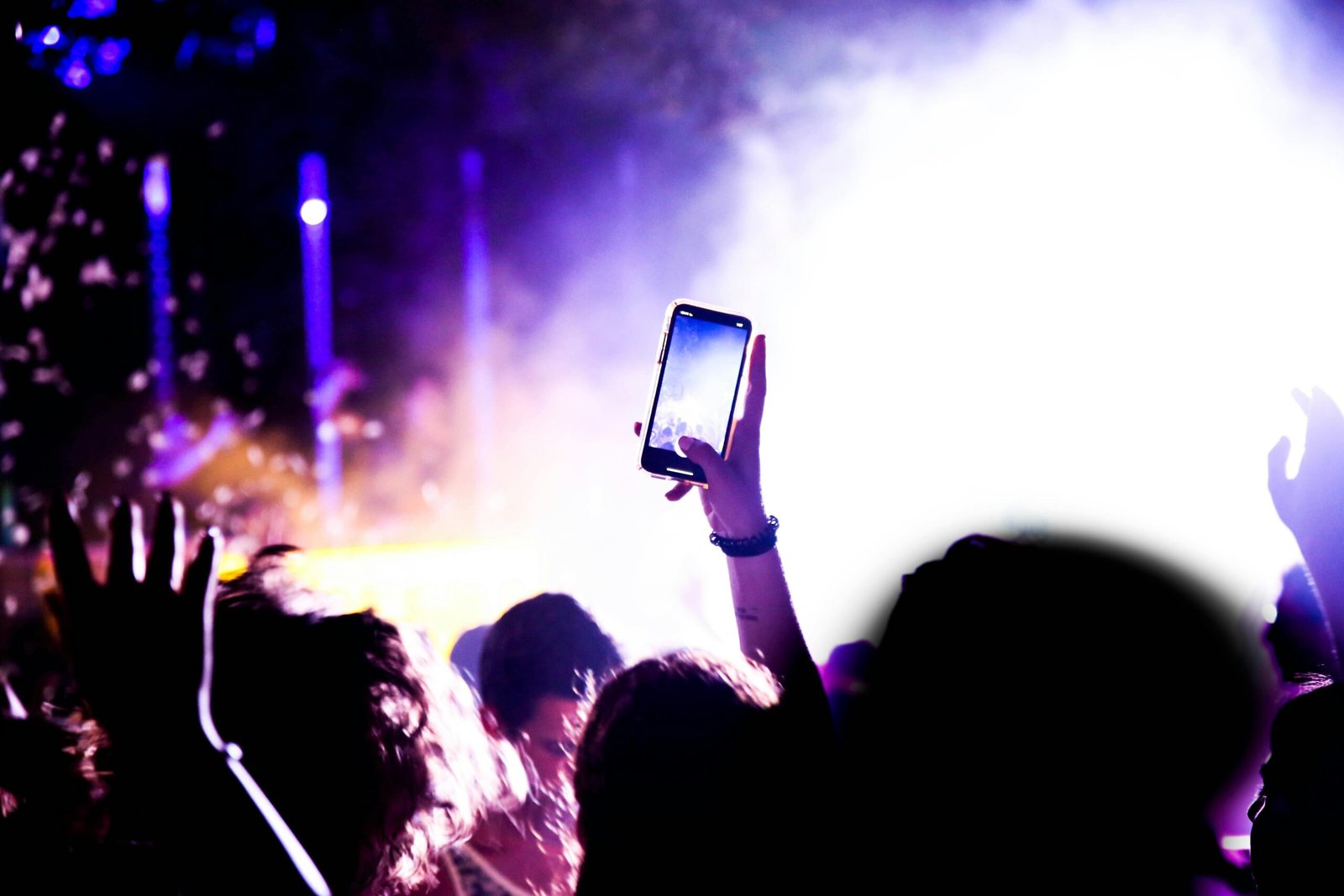 A vibrant crowd at a concert, hands raised in excitement, illuminated by thrilling 3D Glow Gellyball and Mobile Glow Parties.